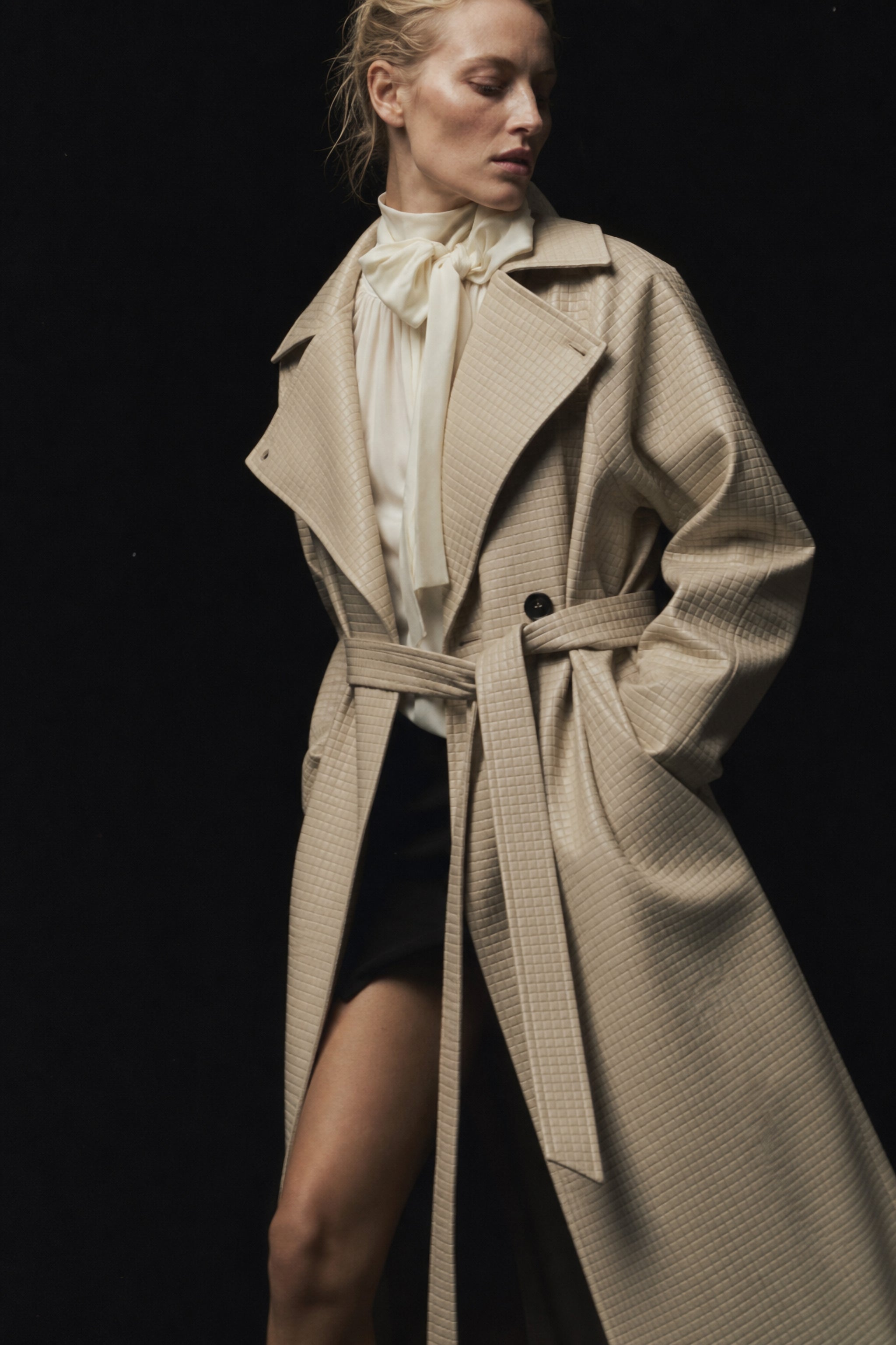 Embossed check faux leather trench coat in beige editorial image 1