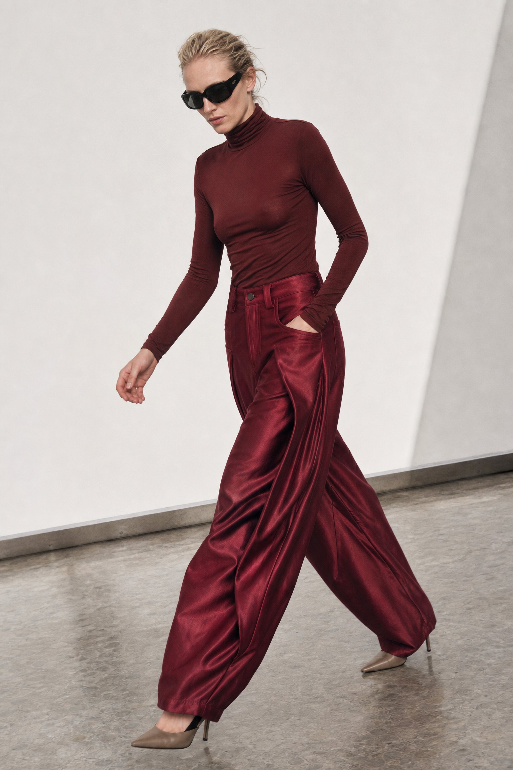 Satin pleated wide leg trousers in red editorial image 1