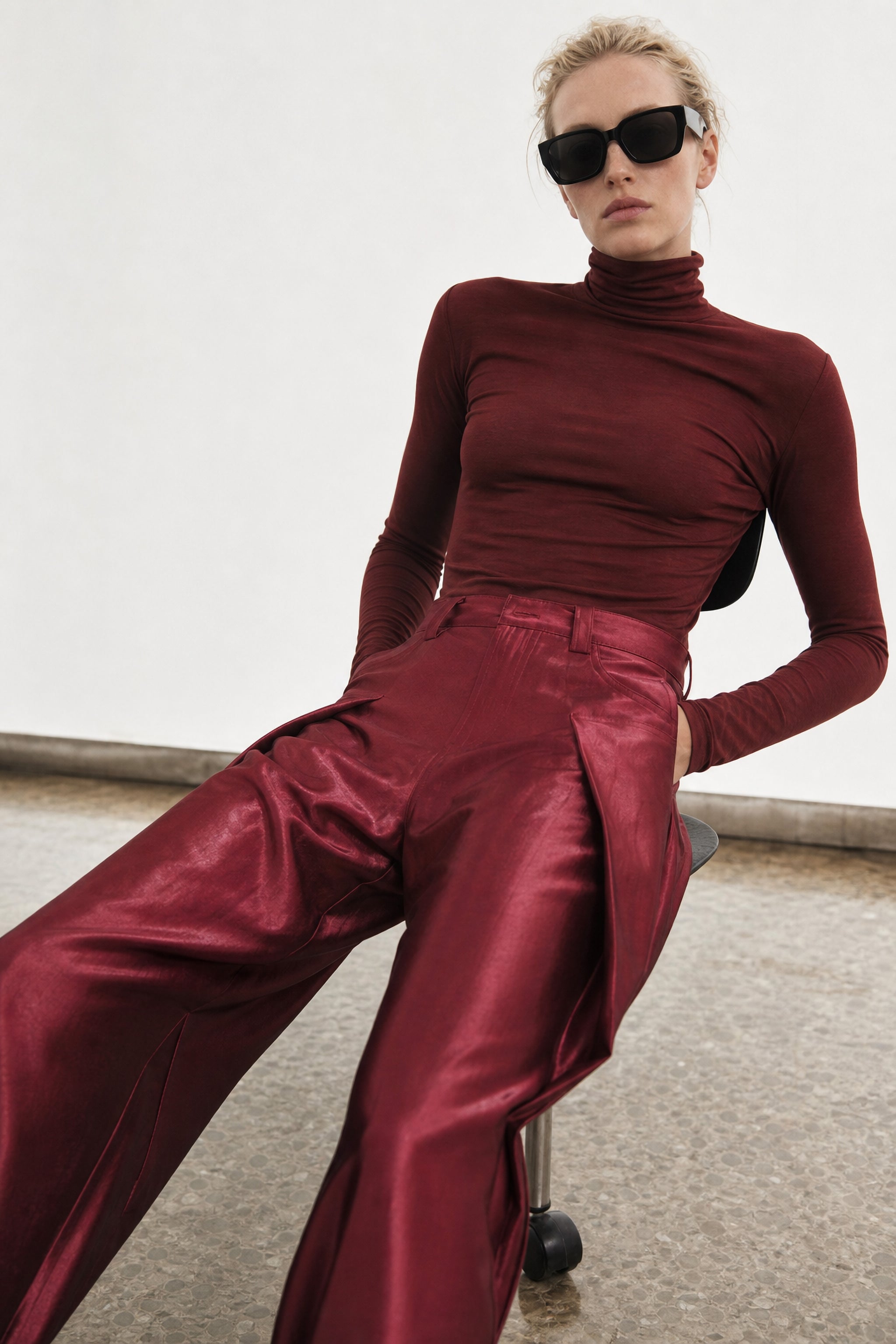 Satin pleated wide leg trousers in red editorial image 2